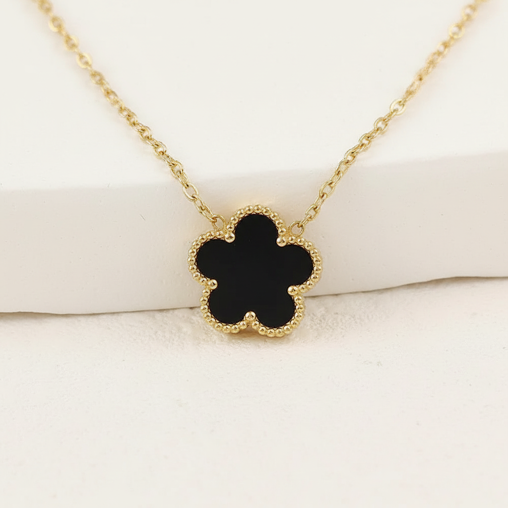 Black clover necklace on white background